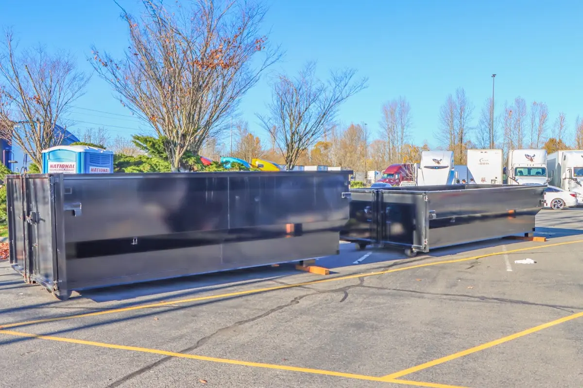 Professional dumpster rental service with roll-off container on residential driveway in Sandy Oaks